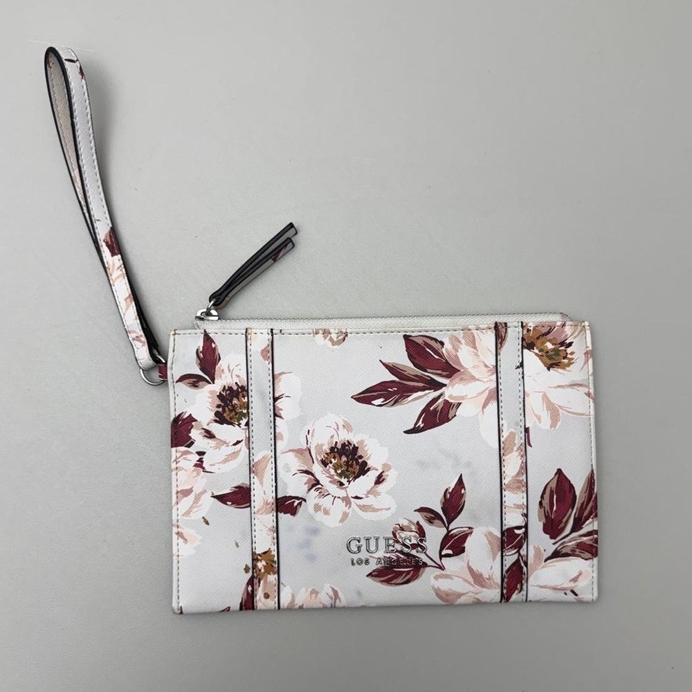 Guess floral wristlet with white background and brown and beige flowers